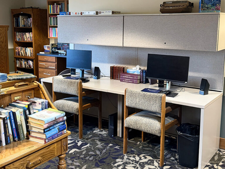 Library desk area with 2 computers.
