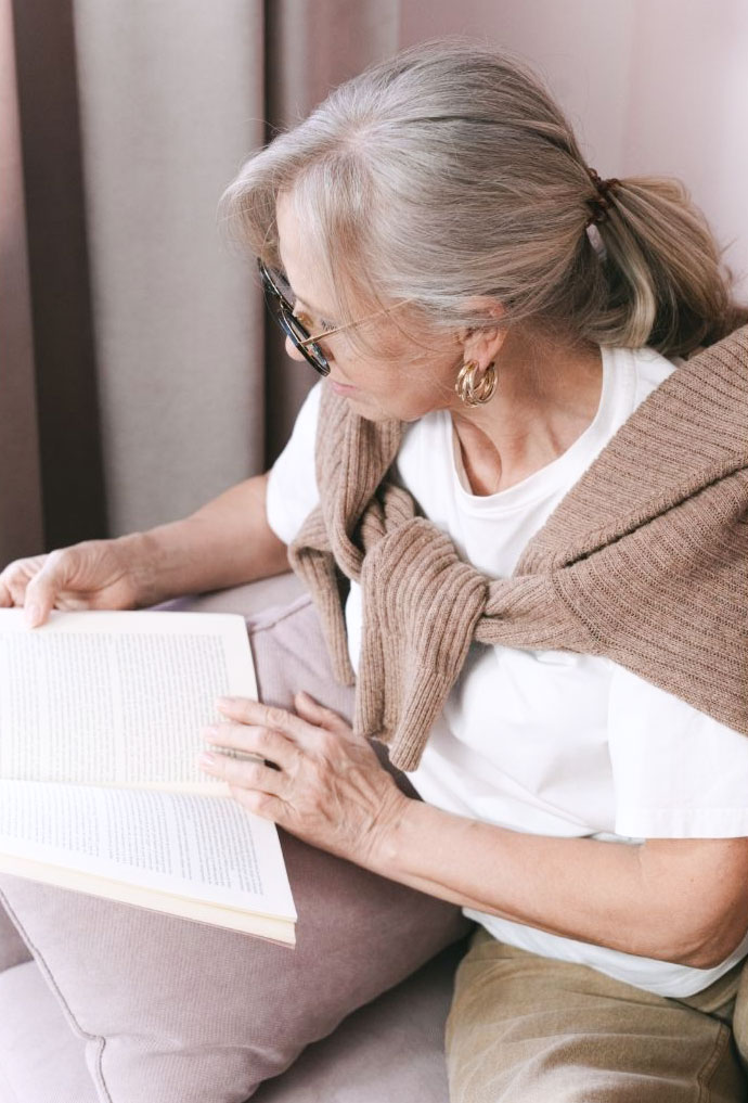 Elderly woman reading a book.